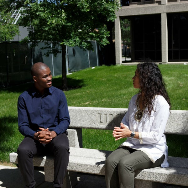 students talking on a bench