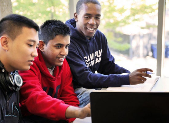 students looking at a laptop