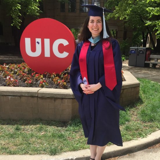 student in front of UIC logo