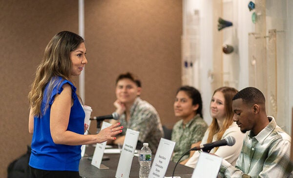 Director Liz Herrera speaks with students before event panel