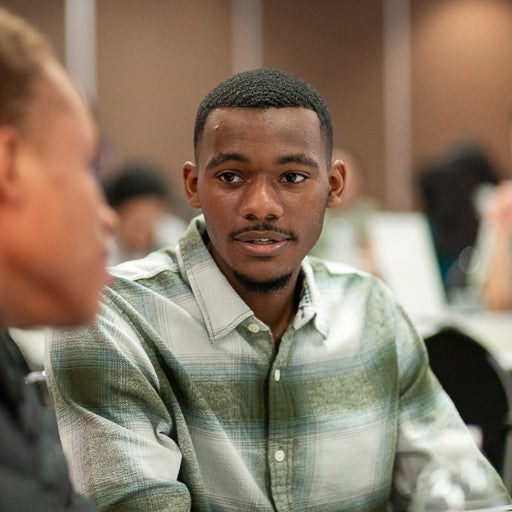 Integrated Health Studies student wearing green flannel shirt at event