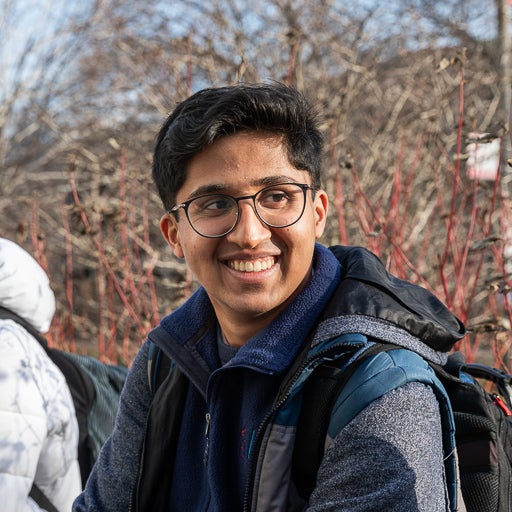 Biochemistry student on campus in the fall smiling in the sun